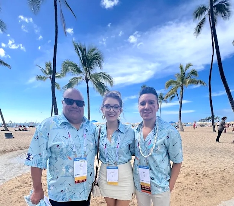 Team wearing branded Hawaiian shirts with business logo at a company or trade show event